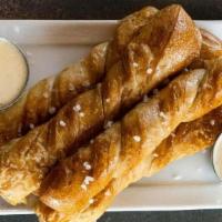 Pretzels · Hot, fresh baked pretzels with house-made beer cheese sauce.