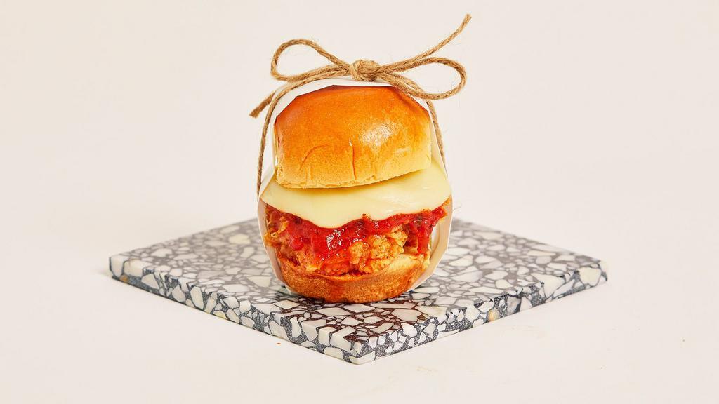 Chicken Parm Slider · Crispy fried chicken with melted mozzarella and marinara sauce on a toasted bun.