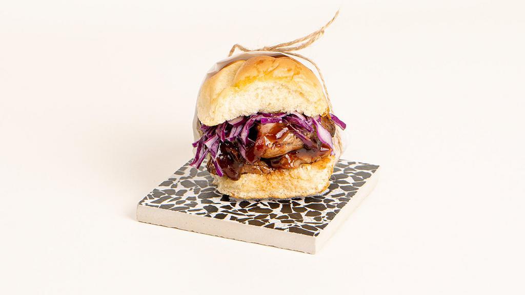 Bbq Pulled Pork Slider · Tender pulled pork with bbq sauce, coleslaw, and pickles on a toasted bun.