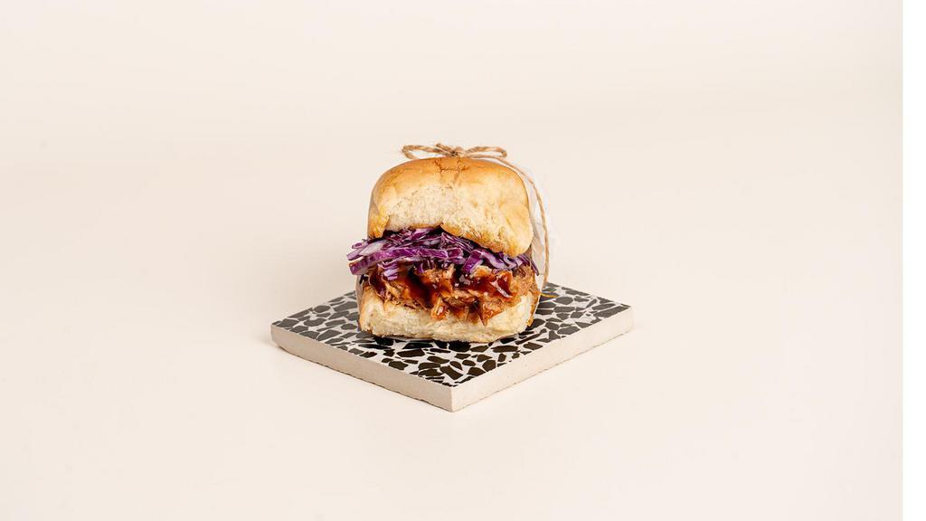 Bbq Chicken Slider · Tender pulled chicken with bbq sauce, coleslaw, and pickles on a toasted bun.