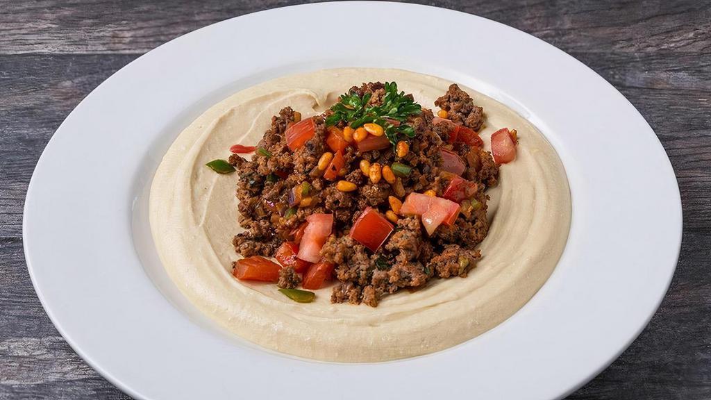Hummus With Kafta Beef* · ground beef mixed with minced onions, diced tomatoes, jalapeno, parsley, mediterrranean seasoning, pomegranate molasses, choice of hummus, toasted pine nuts, pita