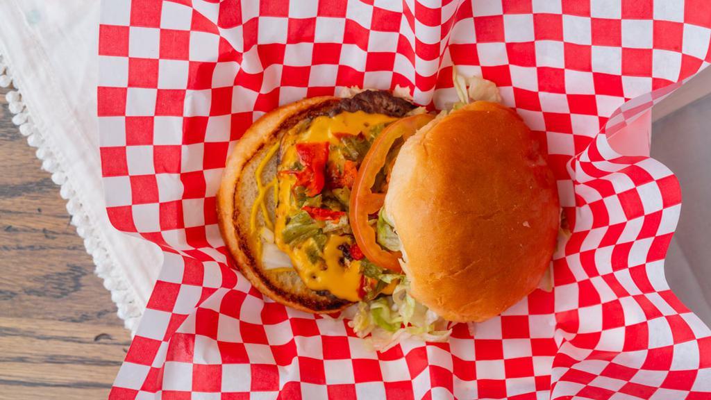 Green Chile Cheeseburger · Single meat with cheese, green chile, lettuce, tomatoes, onion and mustard. Served with fries and a 24 oz. drink.
