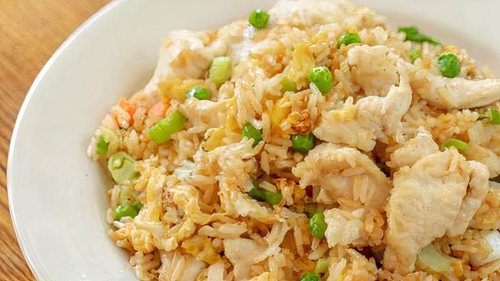 Chicken Fried Rice · Authentic fried rice cooked with egg, peas and carrots, green onions.