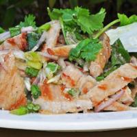 Nam Tok Salad · Salad mixes slices of grilled pork or beef with shallots, green onion, mint, and cilantro. T...