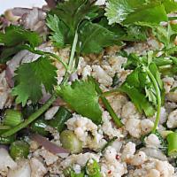 Larb Gai Salad · Minced chicken salad with shallots, green onion, mint, and ground roasted rice. In lime chil...