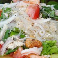 Yum Woon Sen (Glass Noodles Salad) · Thai salad of glass noodles tossed with yellow onion, tomato, celery, steamed chopped chicke...