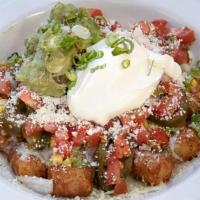 Tater Torta Sandwich · Twice fried tater tots, refried black beans, pico de gallo, Swiss cheese, sour cream, lettuc...