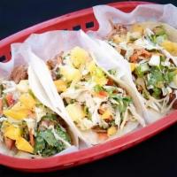 Bbq Pork Tacos · BBQ sauce, slow roasted pork, avocado lime crema, coleslaw, and mango pineapple pico. Served...