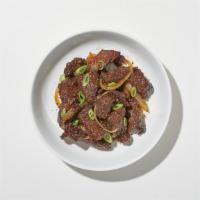 Black Pepper Beef · Tender sliced steak sautéed with white onions, bell pepper, and carrots in a garlic and blac...