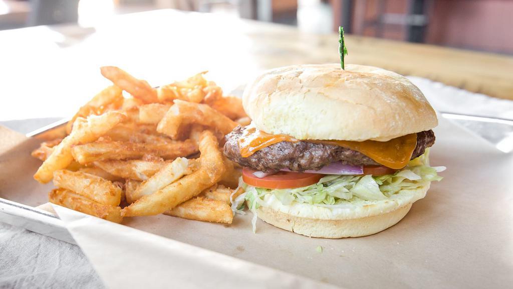 The T-Rex Burger · 1/2lb. Black Angus burger patty, lettuce, roma tomatoes, onions, and roasted garlic mayo. You may choose between Cheddar or Swiss cheese below. Comes with your choice of fries or Greek salad.