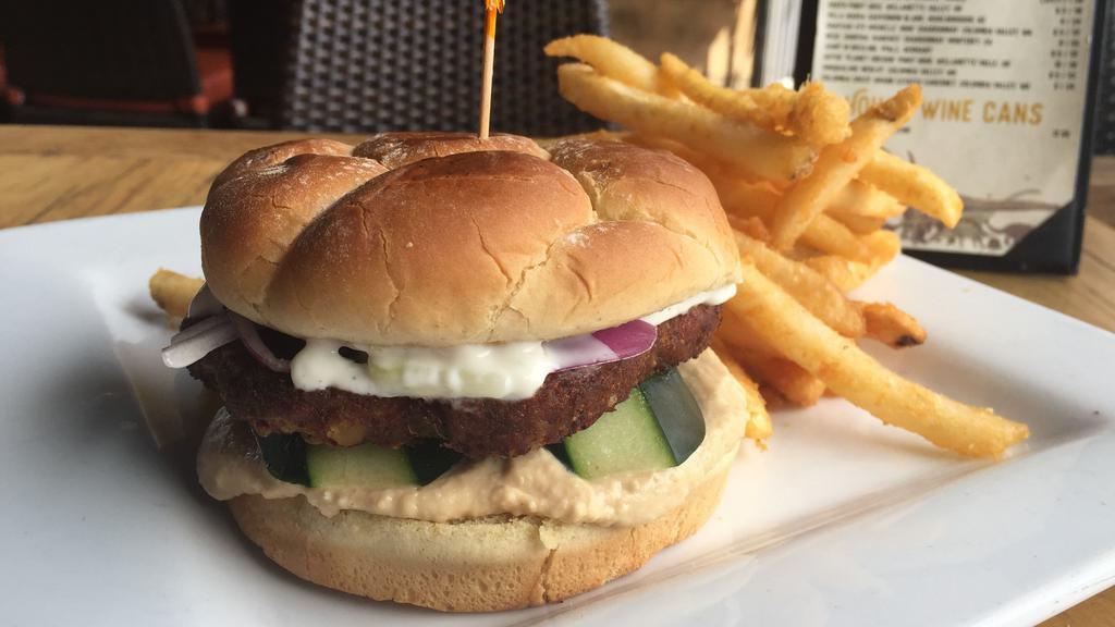 Stegosaurus Veggie Burger · Roasted quinoa and garlic patty, traditional hummus, cucumber, onion, and tzatziki. Comes with your choice of fries or Greek salad.