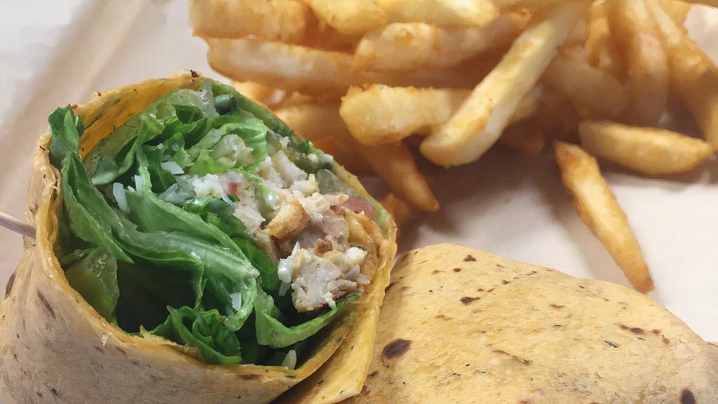 Chicken Caesar Wrap · Tomato/Basil wrap with grilled chicken breast, romaine lettuce, croutons, parmesan, roma tomatoes, and caesar dressing.  Comes with your choice of fries or Greek salad.