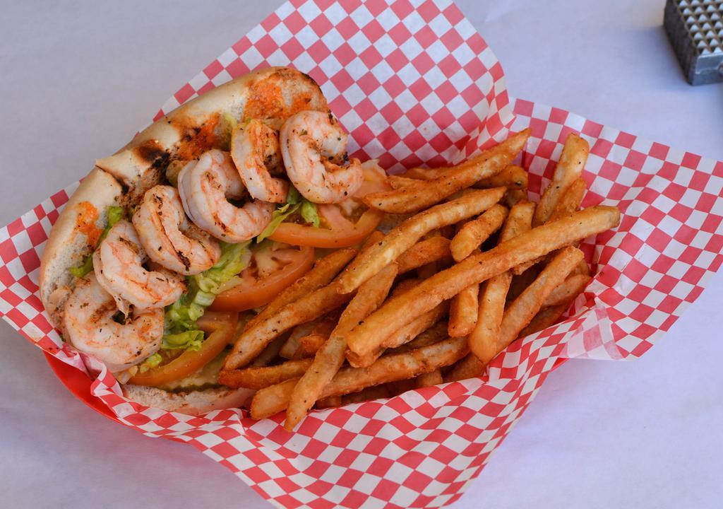 Grilled Shrimp Po Boy · Garlic butter grilled shrimp served with lettuce, tomato, pickle, and Cajun Mayo on a toasted baguette.