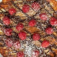 Chocolate Raz-Enkoek · Panenkoek with raspberries chocolate drizzle and chocolate truffle bits.