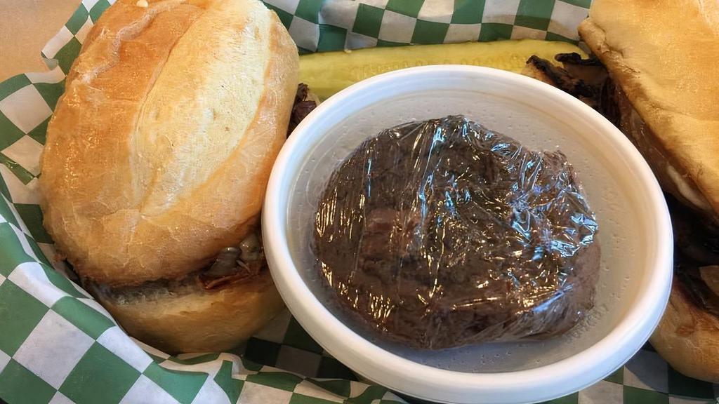 French Dip · Grilled steak and onions with melted swiss cheese on a baguette with au jus.