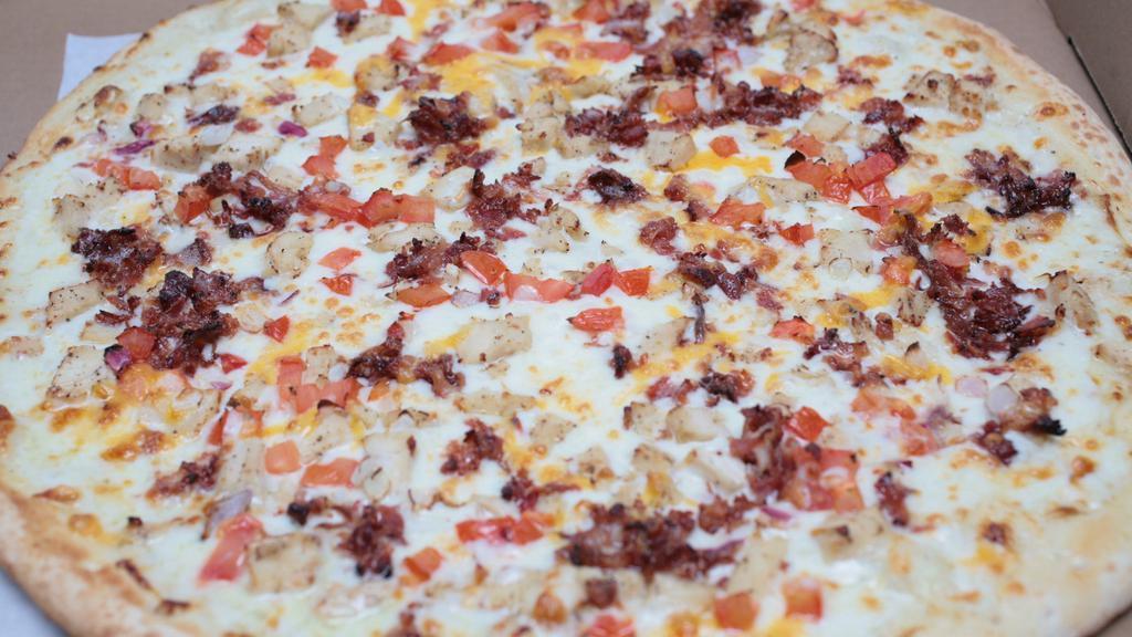 Grilled Chicken Gourmet Pizza · Grilled chicken, crispy bacon, onions and roma tomatoes. Made with creamy gourmet garlic white sauce.
