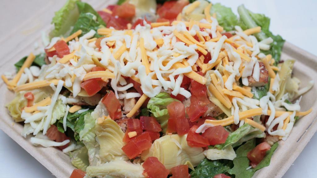 Chicken Caesar Salad · Grilled chicken, parmesan, artichoke hearts, tomatoes and cheese. Made with fresh romaine lettuce.
