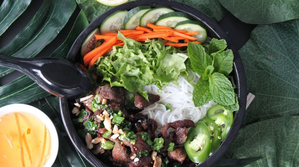 Vermicelli Bowl (Bun Thit Nuong) · Lettuce, cucumber, mint, basil, jalapenos, pickled carrots on rice noodles. Served with a light, sweet fish sauce.