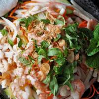 Lotus Root Salad · Shrimp, pork, lotus roots, cucumber, and carrots. Served with chips and fish sauce.