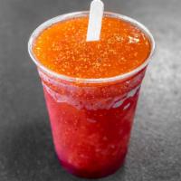 Mangoneada · Natural mango popsicle dipped in chamoy sauce, lime and chili powder
