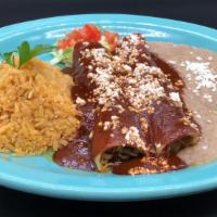 Mole Enchiladas · Two corn tortillas filled with your choice of meat, topped with sweet mole sauce and jack ch...