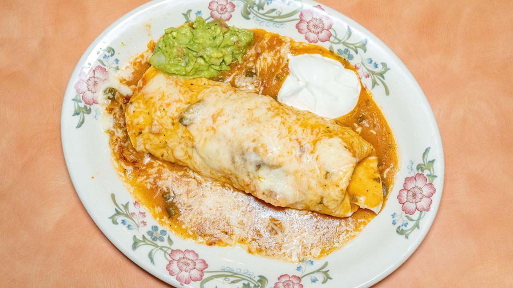 Burrito Colorado · Beef braised in a mild red sauce, rice, and beans. Wrapped in a flour tortilla, smothered with green chile, cheese, sour cream, and guacamole.