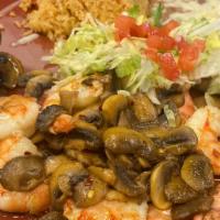 Camarones Al Mojo De Ajo · Large shrimp sauteed in garlic sauce, cooked with fresh mushrooms, served with rice and beans.