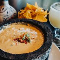 Molcajete Cheese Dip · creamy queso dip with chipotles en adobo, poblano peppers, red bell peppers, house-made corn...