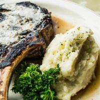 Daniel'S Bone-In Rib-Eye 30 Oz · topped with our signature steak butter and served with garlic mashed potatoes, jumbo baked p...