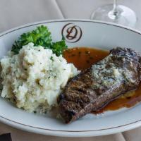 New York 12 Oz · topped with our signature steak butter and served with garlic mashed potatoes, jumbo baked p...