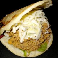 Beef Arepa · A grilled corn Arepa with our seasoned Shredded beef, mozzarella cheese and mixed greens wit...