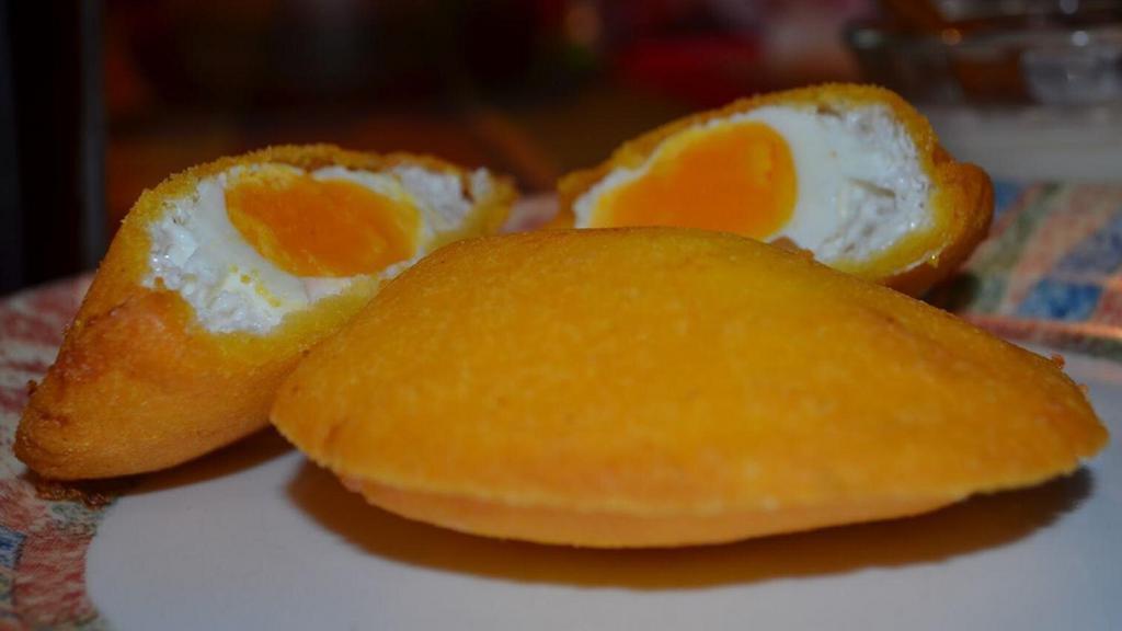 Egg Arepa · An Arepa made of corn flour that is stuffed with an egg and then deep fried.