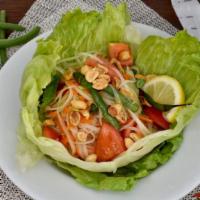 Papaya Salad · Fresh shredded green papaya, Thai chili, garlic tomatoes, carrots, and green beans served wi...