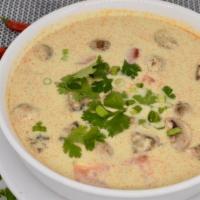 Tom Kha Soup · Classic Thai coconut milk soup with lemongrass, white onions, mushrooms, and tomatoes. Toppe...
