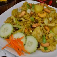 Pineapple Fried Rice · Fried rice with yellow curry powder, choice of meat, egg, white onions, raisins, cashew nuts...