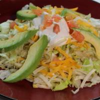 Avocado Slices Tostada · Served with re-fried beans and your choice of meat. Topped with lettuce, cheese, sour cream,...