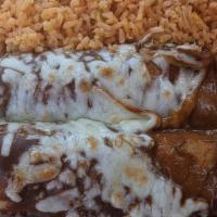 Mole Enchiladas · Two corn tortillas stuffed with your choice of meat. Topped with cheese and a sweet and spic...