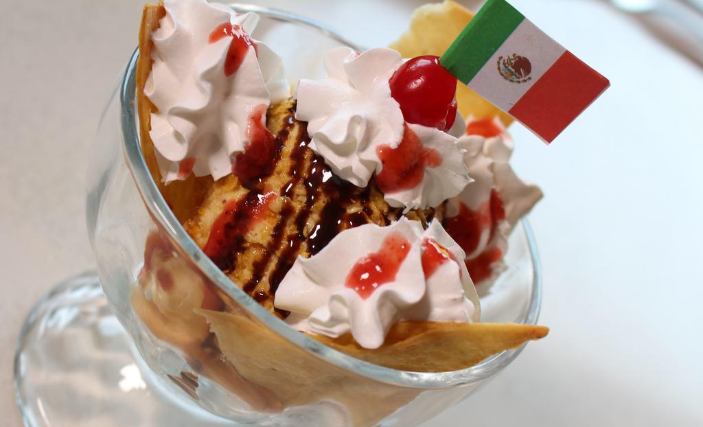 Deep Fried Ice Cream · Your choice of chocolate or vanilla ice cream in a crisp cinnamon crumb coating. Served in a flour tortilla bowl and topped with strawberry sauce, honey and whipped cream.