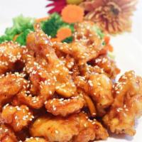 Sesame Chicken · Battered fried chicken coated in a sweet orange sauce topped with sesame seeds. Side of stea...