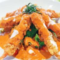 Fish Chu Chee · Crispy fish fillet with bell pepper, onions, and Thai basil in red curry sauce.
