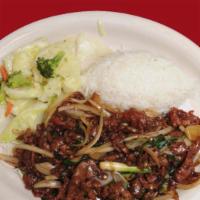 Mongolian Beef · Sliced tender beef with green onions, white onion and crispy rice noodles.