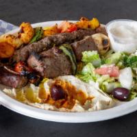 Mix Grill Plate · Three skewers of kababs, chicken, beef and Kafta served with rice, hummus, Greek salad, pita...