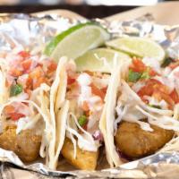 Three Baja Fish Tacos · Our fish tacos are made with beer-battered Alaskan Pollock and served in corn tortillas with...