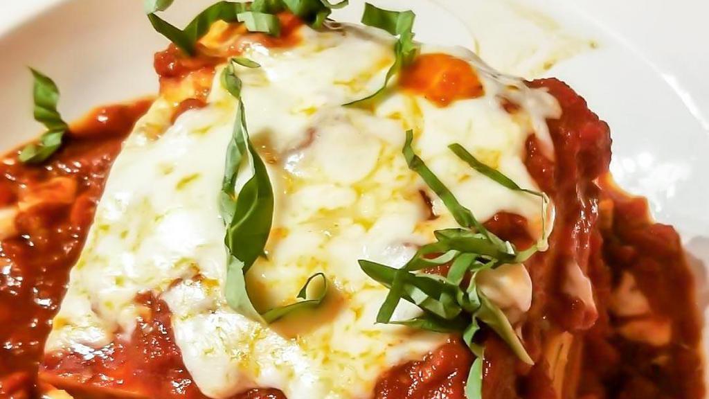 Lasagna · Layers of fresh pasta, bolognese, béchamel, parmesan, mozzarella, basil, and marinara.