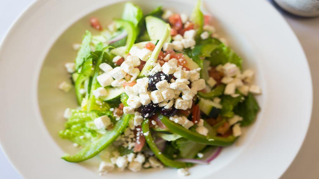 Greek Salad · Chopped romaine tossed with tomatoes, cucumbers, red onions, peppers, kalamata olives, feta cheese, and balsamic vinaigrette.