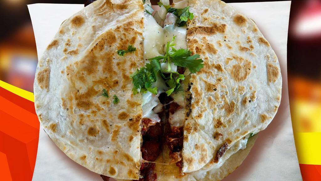 Gringa · Flour tortilla, pastor, cheese, onions, and cilantro.