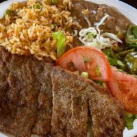 Milanesa Plate · Breaded steak with salad, rice and beans