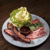 Pork Belly Lettuce Wraps · Butter Lettuce, Choi's Kimchi, Pickled Carrots + Daikons, Cilantro + Gochujang
