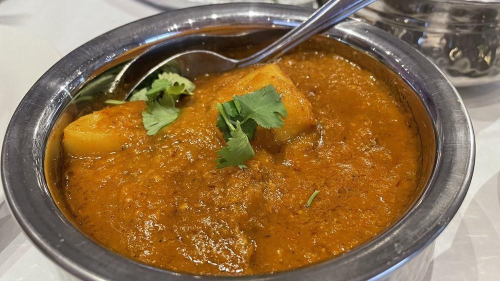Lamb Vindaloo · Lamb cooked with potatoes in a traditional goan sauce with fiery red chili paste and a slight tang from vinegar.