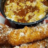 Mozzarella Sticks · 6 beer-battered and deep-fried mozzarella served with a side of house tomato gravy